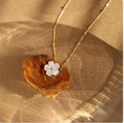 Bloom Charm Necklace featuring an elegant floral pendant on a gold chain, beautifully displayed on natural background.